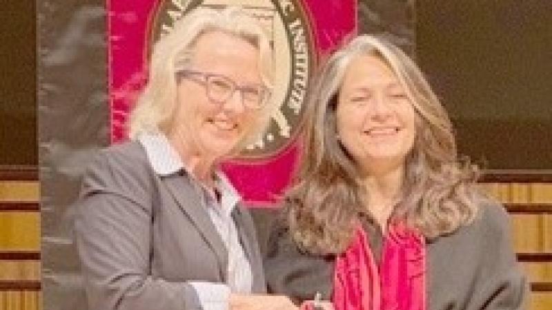 Dr. Rebecca Doerge, Provost, presenting Dr. Azita Hirsa with award