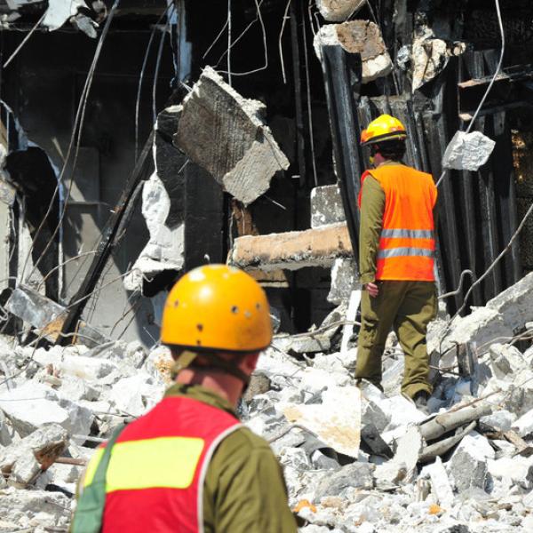 Two engineers on the scene of a destroyed building